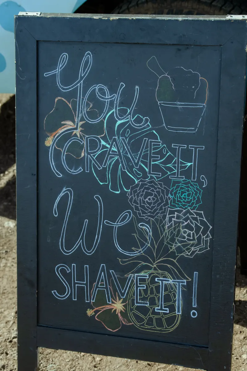 Chalkboard sign reading You crave it, we shave it