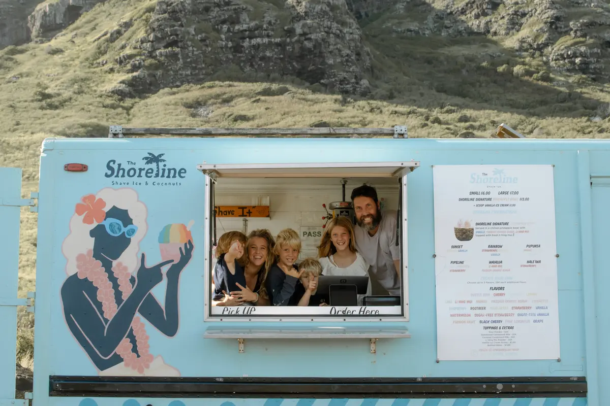 The whole family smiling from the order window