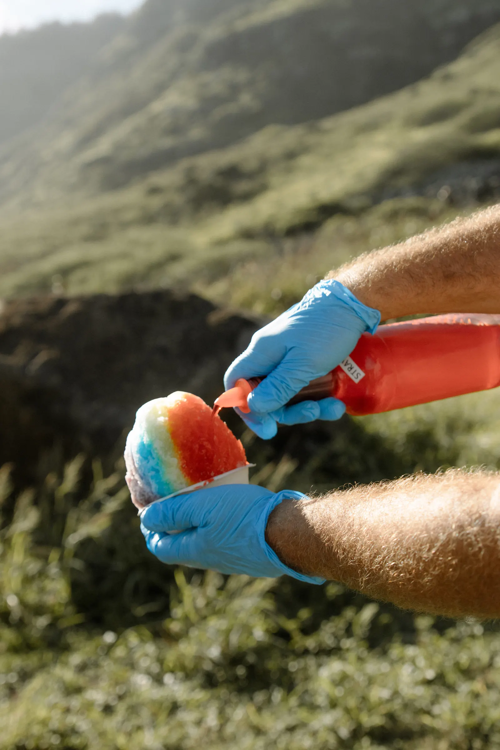 Island syrup being poured over shave ice