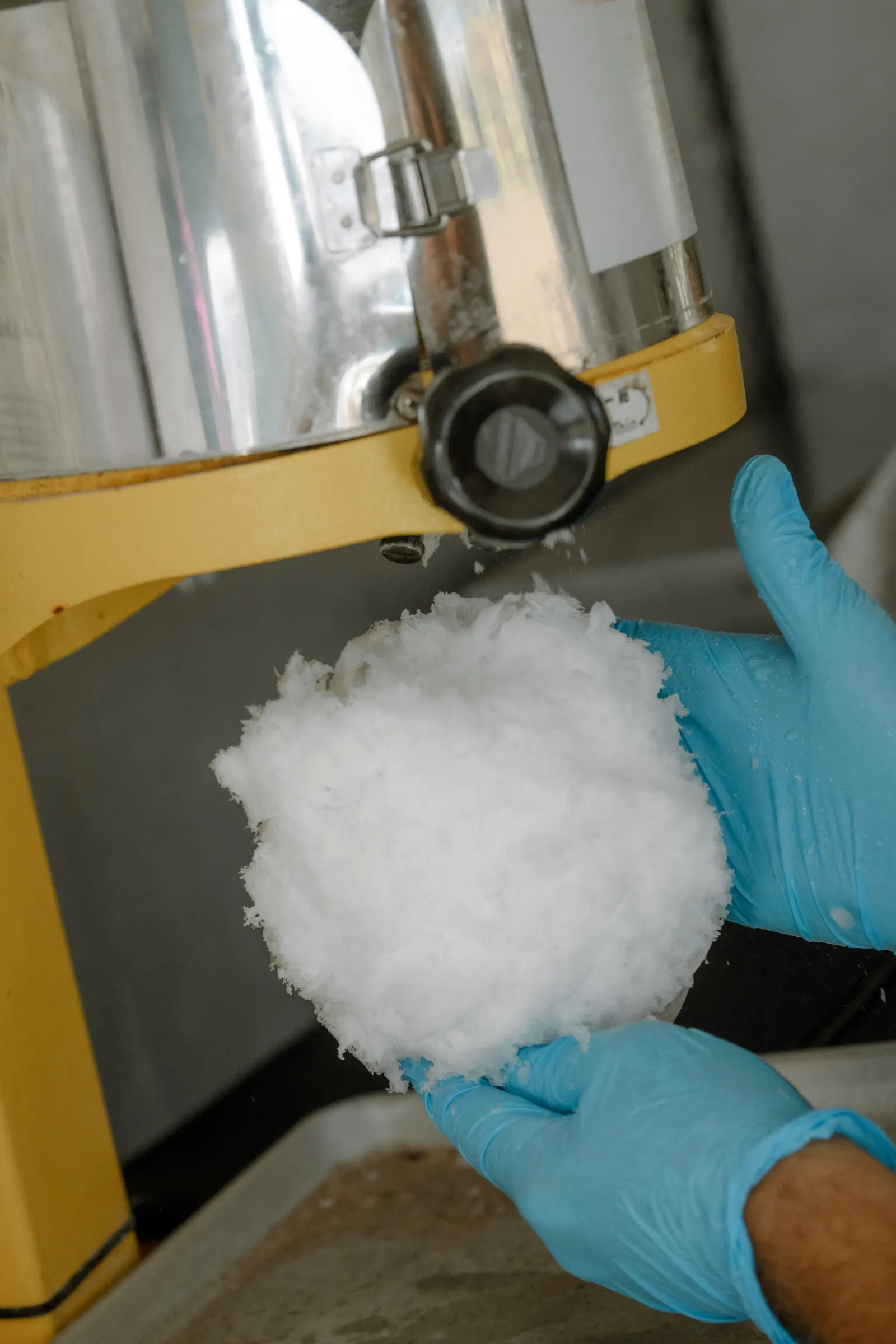 Fresh, fluffy shave ice coming off the machine